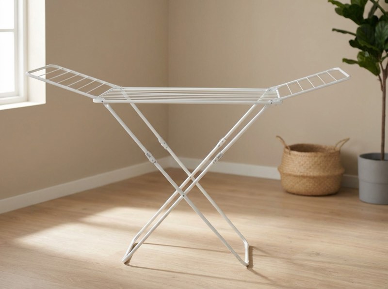 A white folding steel drying rack in a laundry room.